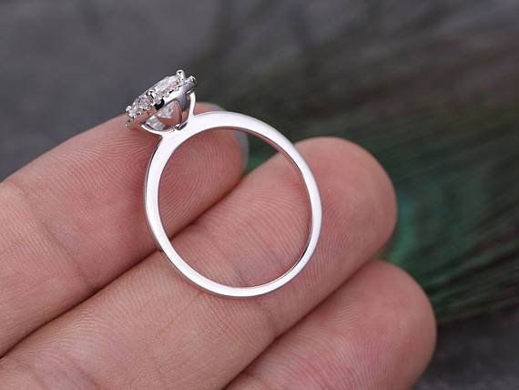 Oval cut Moissanite and Diamond Halo Engagement Ring in 10k Rose Gold
