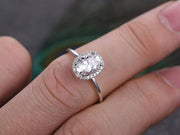 Oval cut Moissanite and Diamond Halo Engagement Ring 