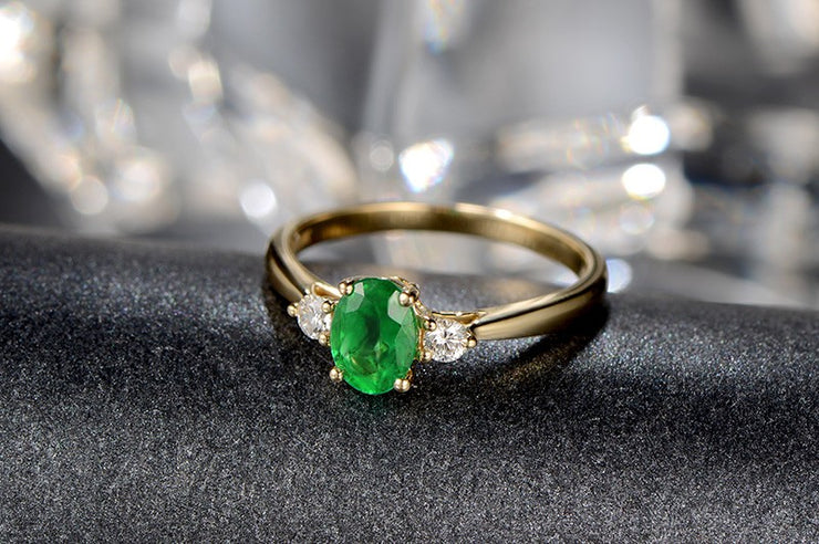 Trilogy Half Carat oval cut Emerald and Round Moissanite Diamond Engagement Ring in Yellow Gold