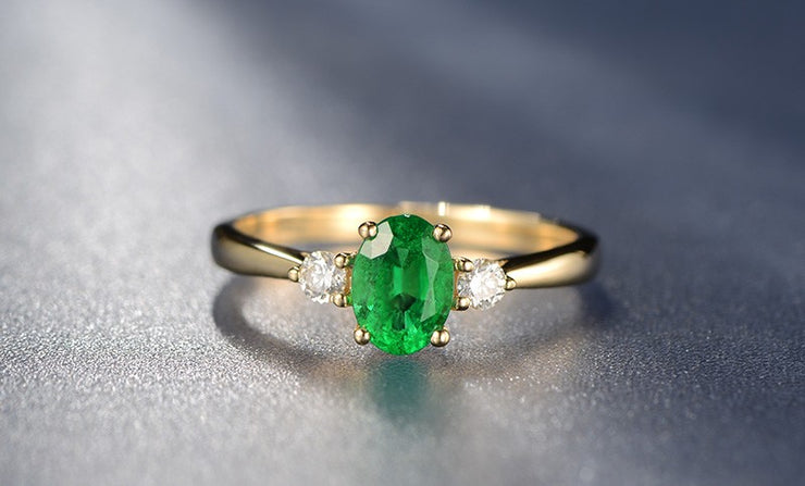 Trilogy Half Carat oval cut Emerald and Round Moissanite Diamond Engagement Ring in Yellow Gold